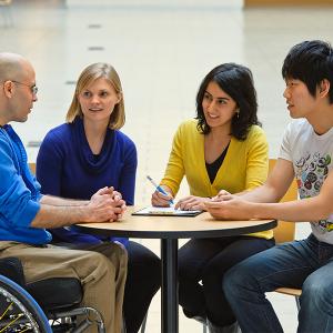 Photo of students having a conversation with their health mentor