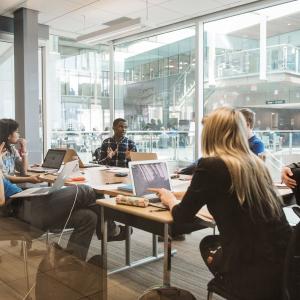 Photo of UBC students discussing with each other at a table