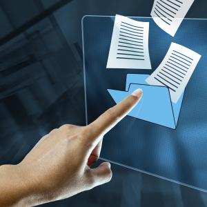 Photo of finger posting at documents coming out of a folder