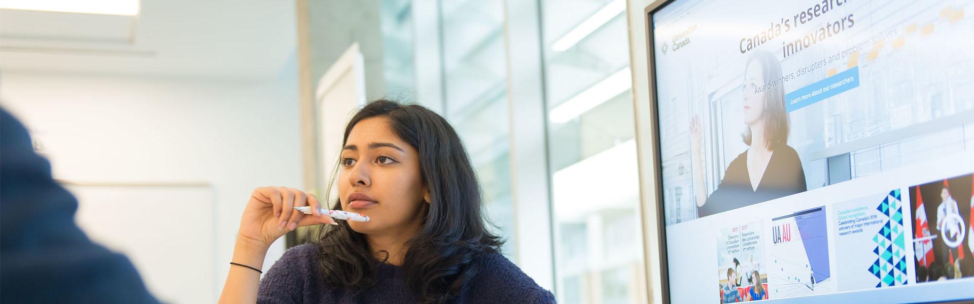 Photo of student in research meeting